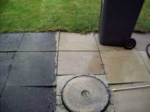 A patio in the process of  being pressure washed
